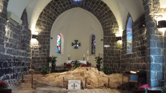 Interior of the church, with the large rocky outcrop dominant in the space
