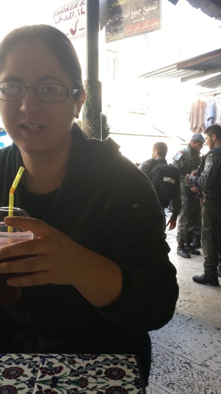 One last pomegranate juice in the suk, with Palestinian police in the background